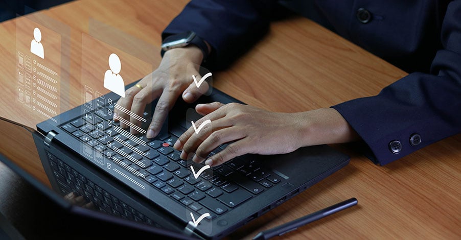Professional typing on a laptop with a digital checklist overlay, representing Microsoft Teams Phone licensing and deployment evaluation.