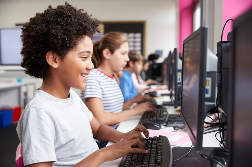 Students working on computers in an EDCOE classroom